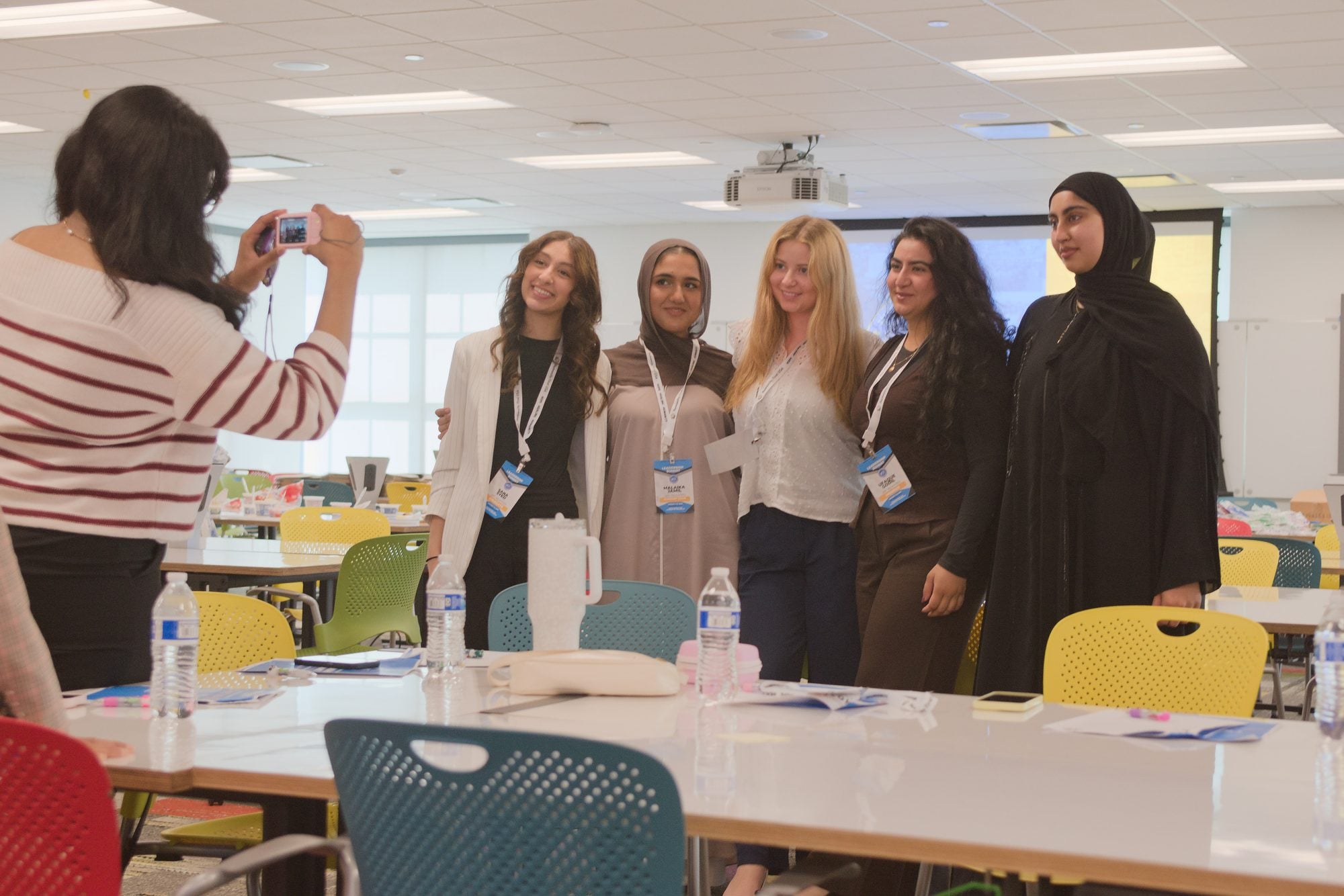 Delegates pose for a group photo between sessions in a Summit 2026 workshop room