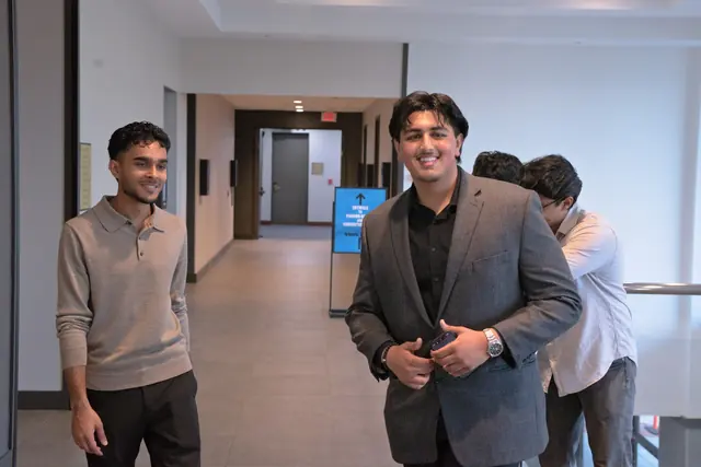 Two smiling young men in the hallway arrive for the evening at the Gift of Health Gala 2026.