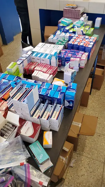Neatly stacked boxes of donated medicines and supplies fill a long table in the pharmacy area of the Guatemala clinic.