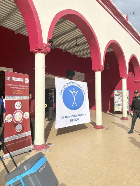 A Humanity First Mexico banner stands beneath red arches at the entrance to the clinic site at the Gift of Health mission in Mexico.