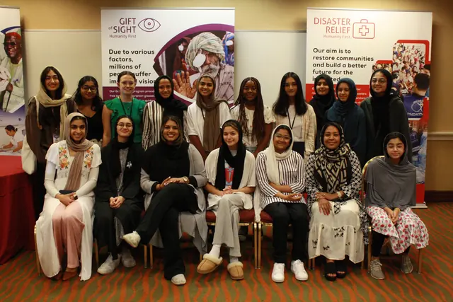 Women delegates gather for a group photo in front of Gift of Sight and Disaster Relief banners at the HFSD Leadership Summit '23.