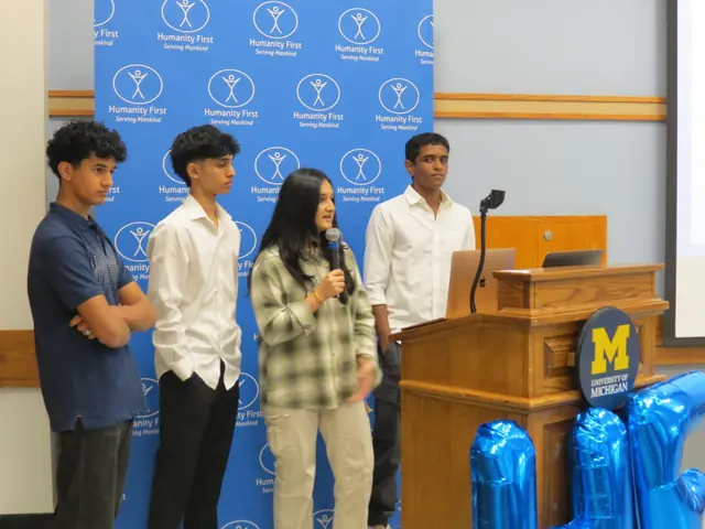 A chapter team presents in front of the Humanity First backdrop