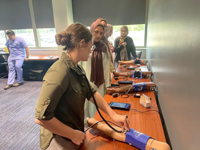 A student practices taking blood pressure on a training arm at a skills station during the 2025 Leadership Summit.