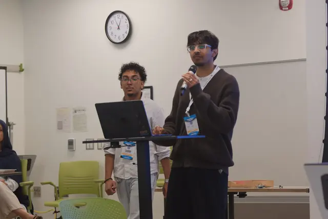 A student speaks at the podium with a microphone during a Summit 2026 workshop